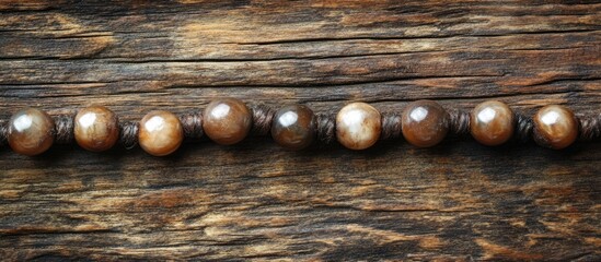 Poster - Wooden beads necklace on rustic wooden background with copy space for text