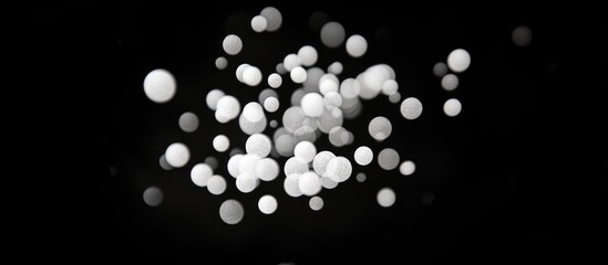 Poster - Abstract white bokeh lights on a black background creating a dreamlike visual effect with Copy Space for text placement