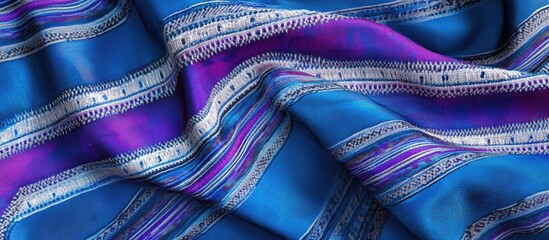 Poster - Colorful textured fabric with intricate patterns in shades of blue and purple with decorative stripes ideal for textile backgrounds Copy Space