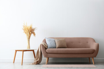 Poster - sofa in mocha mousse shade and decor indoors. interior with trendy color of 2025 year