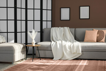 Wall Mural - Cozy living room interior in mocha mousse shade. Brown wall and dark beige carpet. Trendy color of 2025 year