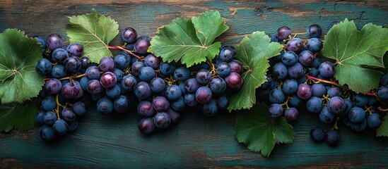Aufkleber - Fresh purple grapes with green leaves arranged on rustic wooden surface Copy Space