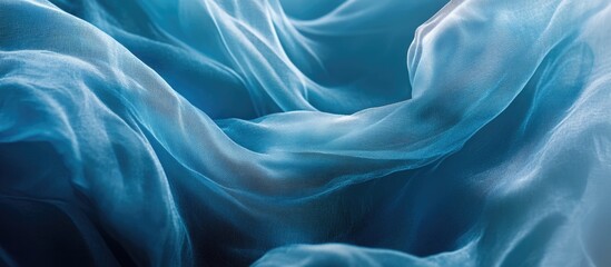 Poster - Blue sheer fabric background with smooth flowing textures and folds for design purposes Copy Space