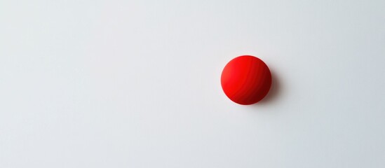 Poster - Red spherical object positioned on a white background with ample copy space for text insertion