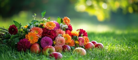 Poster - Colorful bouquet of flowers and fresh apples arranged on green grass with blurred background and natural light, Copy Space