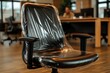 © Ingvar Shelly - office furniture renovation, an office chair with a glossy plastic-wrapped seat in a blurred open-plan office with co-workers in the background