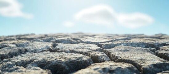 Aufkleber - Cracked dry earth surface with blue sky and clouds in background natural texture landscape Copy Space