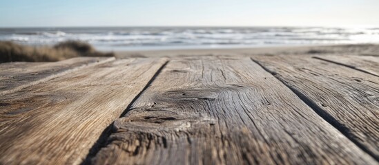 Poster - Wooden table surface with textured grains overlooking a beach and ocean waves in the background during daylight Copy Space