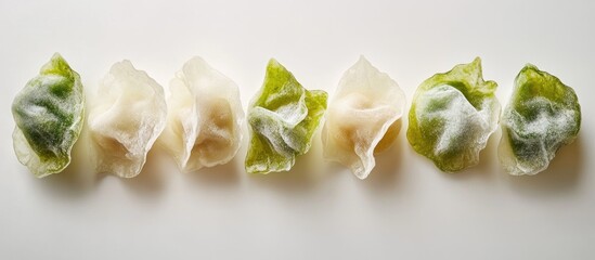 Poster - Assorted color dumplings displayed on a white background with Copy Space for text placement.