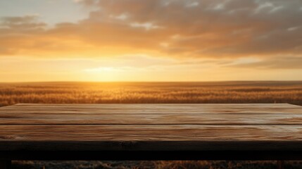 Poster - wooden table surface against a sunset landscape with fields and cloudy sky ideal for placing text or