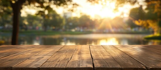 Poster - wooden table surface in foreground with blurred park and sunset background natural lighting copy spa