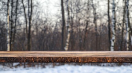 Poster - Wooden countertop or table in foreground with blurred winter forest background and soft light, suitable for product display or advertising Copy Space
