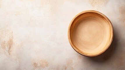 Poster - wooden bowl on textured beige background with ample copy space for text insertion.