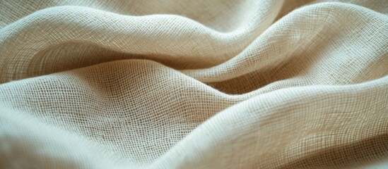 Poster - Textured natural fabric draped with soft folds in neutral beige tones ideal for backgrounds and design with Copy Space