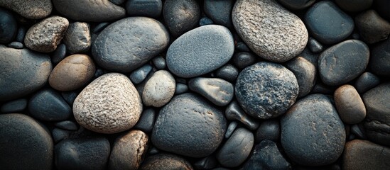 Poster - smooth river stones texture in varying hues and sizes arranged in a natural pattern copy space