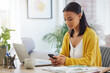 © Nina Lawrenson/peopleimages.com - Phone, contact and woman in home typing email for online university application information. Communication, education and female student with cellphone for virtual college admission form at apartment