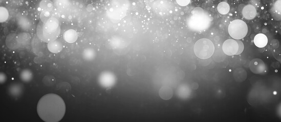 Poster - Silver bokeh lights and sparkle on dark background with copy space for text or graphics