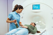 © Dragana Gordic - Medical Professional Assisting Patient Undergoing MRI Scan in Modern Clinical Setting