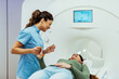 © Dragana Gordic - Healthcare Professional Assisting Patient During MRI Scan Procedure