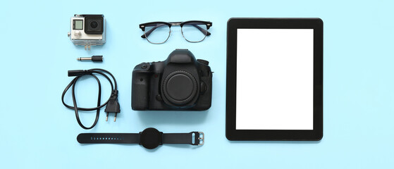 Wall Mural - composition with modern gadgets and glasses on color background