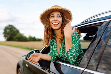 Wall Mural - Woman tourist on road, enjoying window view.  Summer trip. Lifestyle, travel, tourism, nature, active life.