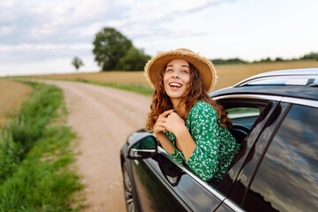 Wall Mural - Woman tourist on road, enjoying window view.  Summer trip. Lifestyle, travel, tourism, nature, active life.