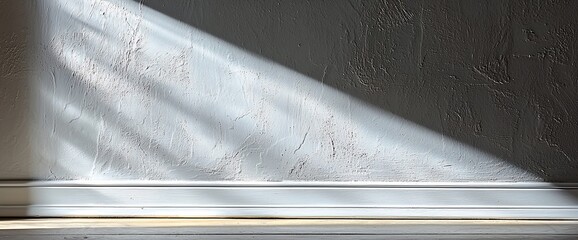 Poster - Sunlight streams through window onto textured wall, baseboard.  Home decor, interior design