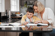 © peopleimages.com - Mother, child or helping with homework in home for learning support, creative development or school project. Education, woman or books with boy drawing for art assignment, knowledge or student growth