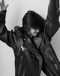 © saulich84 - Portrait of an emotional 7-year-old boy in a large leather jacket posing in a studio. black and white photo.