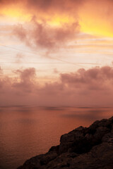 Wall Mural - Serene Sunset Over Rocky Coastline