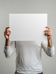 Aufkleber - Individual holds blank poster board against a neutral background showcasing a creative expression of ideas. Generative AI