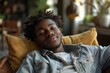 © Vera - Relaxing Black Man on Sofa or Couch