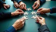 © miss irine - Business team collaborates on jigsaw puzzle. Teamwork, strategy key. Problem-solving. Office environment. Hands assemble puzzle pieces. Diverse group. Creative concept for synergy, connection.
