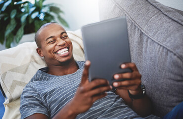 Poster - Relax, smile and man on sofa with tablet for reading, movie subscription or checking video. Home, laughing and happy person on couch with digital app for social media, ebook or online games results