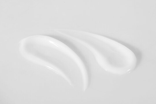 Wall Mural -  - smears of cosmetic product on white background, closeup