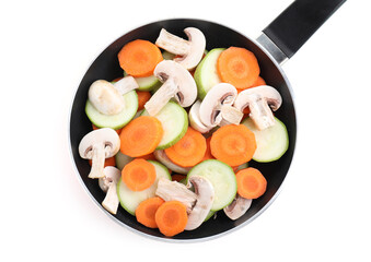 Wall Mural - Frying pan with fresh vegetables and mushrooms isolated on white, top view