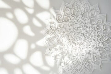 Aufkleber - Intricate white paper mandala with shadow patterns on wall.