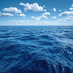 Poster - Open ocean with blue water and white clouds under a bright sky on a sunny day