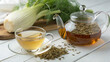 © ameena - Fennel tea in a glass cup, fresh fennel bulb, seeds and tea pot pouring tea to cup. White wooden table with ldetoxification, relaxation, refreshing,ight background