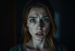 © iushakovsky - Scared female person in a dimly lit room