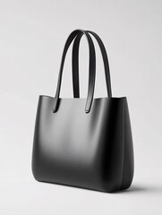 Poster - Minimalist black tote bag with smooth surface and leather handles on white background studio shot