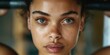 © Soba - Close-up portrait of a person with intense gaze and natural beauty. National African-American Women's Fitness Month