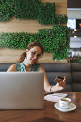 Poster - Laptop, woman and information in cafe for credit card, digital banking and transaction for payment. Restaurant, customer and technology with debit for online shopping, reading details and ecommerce