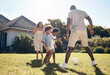 © peopleimages.com - Happy, football and parents playing with children in backyard for bonding, adventure or family time. Fun, outdoor and kids learning soccer with mom and dad in garden for sports development on grass.