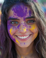 Smiling woman with purple and yellow powder on her face. Holi festival