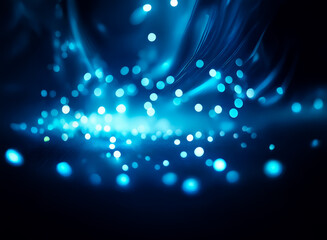 Poster - Abstract image of glowing blue bokeh lights, creating dynamic, swirling patterns against a dark background. The effect suggests movement and energy.