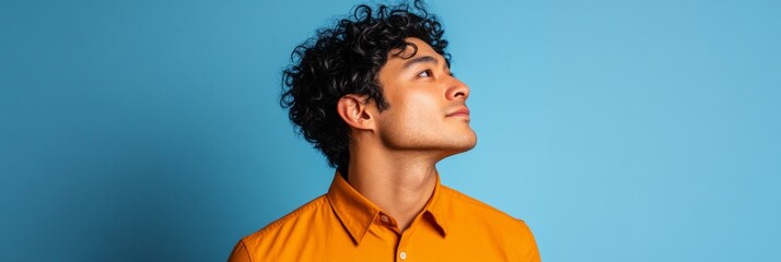 Poster - Modern Professional Portrait for Personal Branding Young Male in Bold Shirt on Minimalist Blue Background - Corporate Growth and Digital Networking Visuals