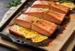 © Prasert - Pan-seared salmon fillet with melted cheese on a baking sheet, appetizer, cheesy delight, comfort food