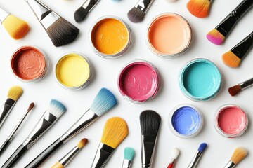 Poster - Various shades of paint and brushes arranged artistically for creative projects in a bright workspace