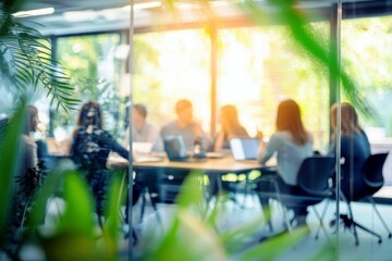 Poster - Focused business meeting in modern office with greenery and blurred participants collaborating on strategy and ideas in bright workspace